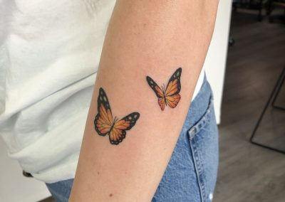 two watercolor monarch butterfly tattoos on forearm by Louise Flowerbloom, Milpitas CA